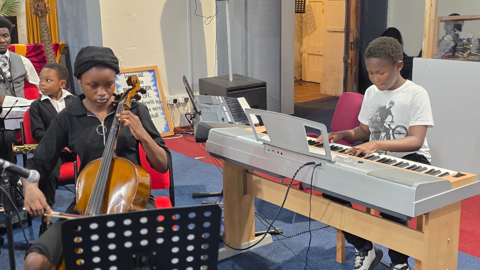 Young student playing keyboard during a Davito Musicals performance