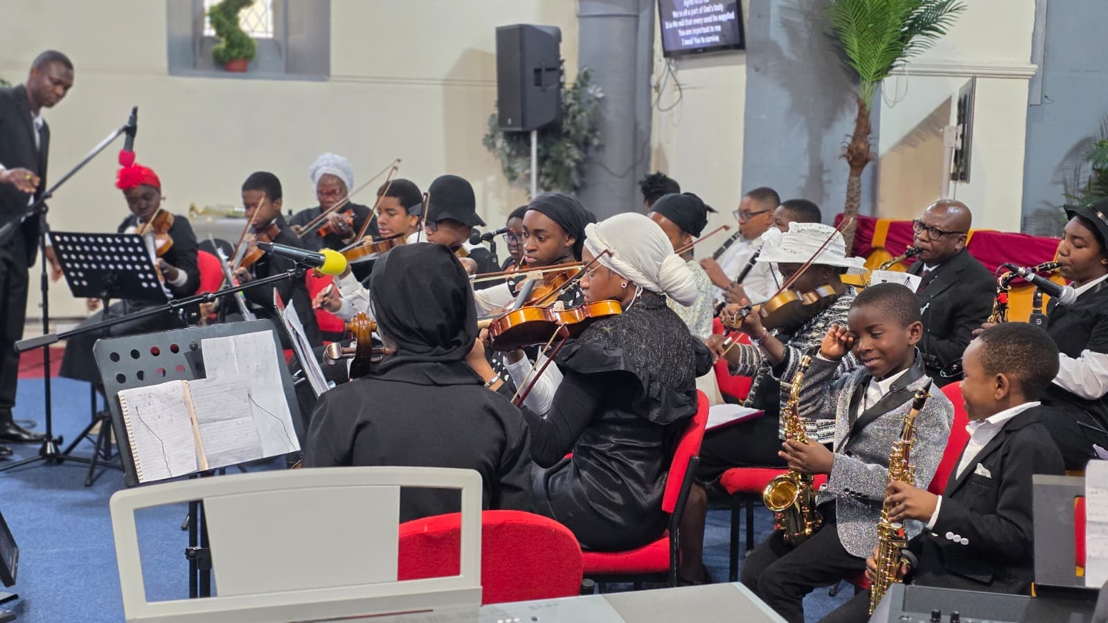 Davito Musicals ensemble with microphones, strings and saxophones